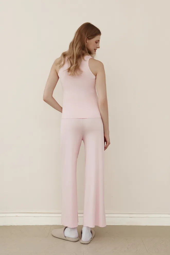 Baby pink wide-leg pants styled for relaxed maternity and postpartum wear