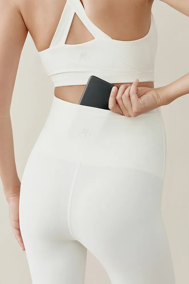 Cream maternity leggings designed to accommodate a growing bump during pregnancy